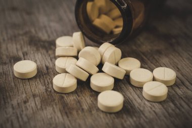 Painkillers on a wooden table background close