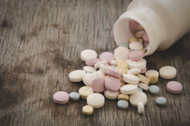Painkillers on a wooden table background close