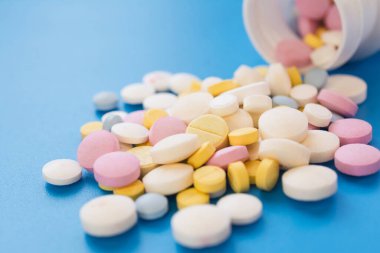 Aspirin tablets on a blue background close up