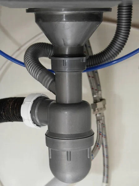 キッチンシンク 配管サービスの下の新しい灰色のプラスチック製の水トラップサイフォン — ストック写真