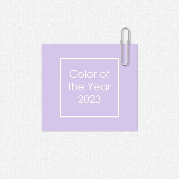 Lavender paper with a paper clip on white background. Digital Lavender Color of the Year 2023. Text Color of the year 2023 in frame