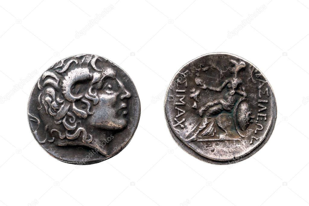 Reverse and obverse of a Greek silver Drachum coin replica of  Alexander the Great dated from 336-323 BC cut out and isolated on a white background, stock photo image