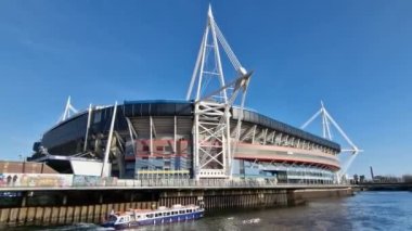 Cardiff, Wales, UK, February 25, 2022 : Principality Stadium (Millennium Stadium) the landmark home of the Welsh National Rugby Union with a water taxi boat cruise trip on the River Taff, stock video footage clip