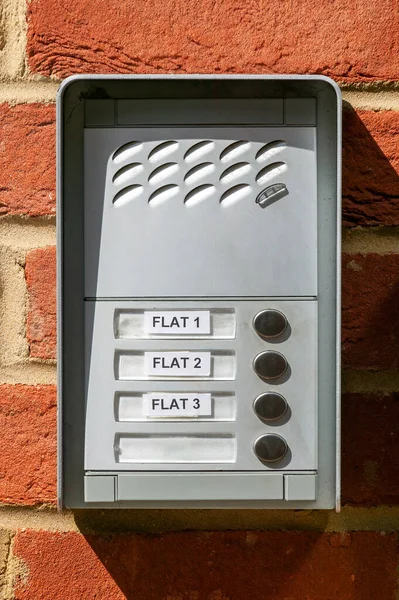 Entry doorbell intercom at a residential apartment building at a house front door, stock photo image