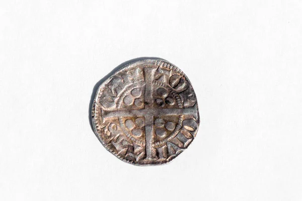 Silver long cross penny English hammered coin of King Henry II of the 14th century dated around 1310- 1314 minted in Canterbury England, reverse cut out and isolated on a white background, stock photo