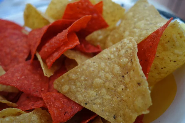 Orange and yellow nacho chips as a close up —  Fotos de Stock