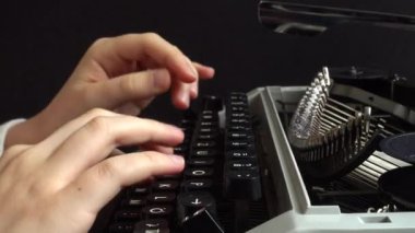 Kız retro bir daktiloyla daktilo yazıyor..