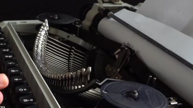 Kız retro bir daktiloyla daktilo yazıyor..
