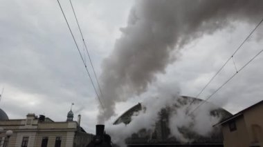 A retro steam locomotive prepares to leave the station.