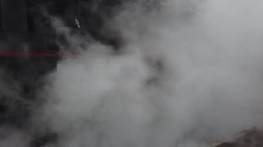 A retro steam locomotive prepares to leave the station.