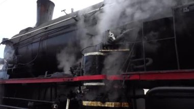 LVIV, UKRAINE - JANUARY 08, 2022: A retro steam locomotive prepares to leave the station.