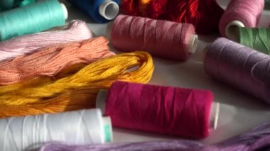 Beyaz arkaplanda izole edilmiş renkli küf ipliklerinin ve çok renkli makaraların üst görünümü.