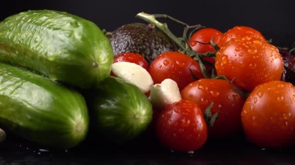 Pomidory Wiśniowe Ogórki Czosnek Awokado Czerwona Cebula Czarnym Tle Kroplach — Wideo stockowe