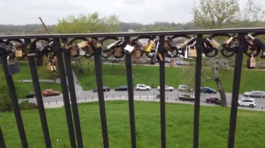 WARSAW, POLAND - APRIL 26, 2022: Dung Hill lookout point with top view of the Vistula river and love padlocks attached to the railing.