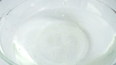 Falling cabbage Brassica oleracea into a glass bowl of water. Slow motion.