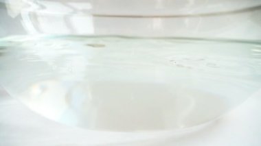 Cam bir kase suya düşen elmalar. Yavaş çekim.