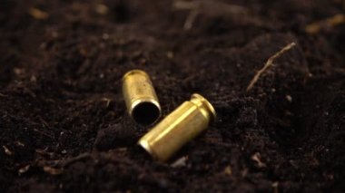 5 mm 'lik bir tabancanın mermi kovanları yere düştü. Yavaş çekim.