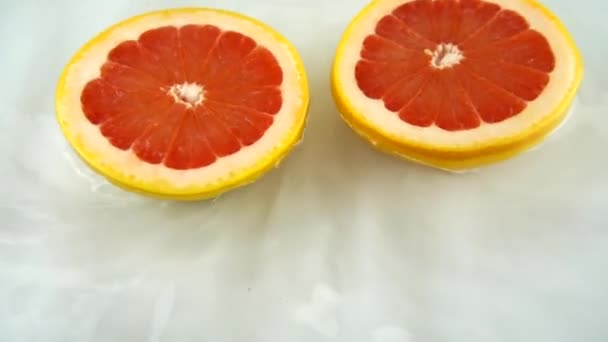Rotating Segments Ripe Juicy Grapefruit Water White Background Slow Motion — Stockvideo