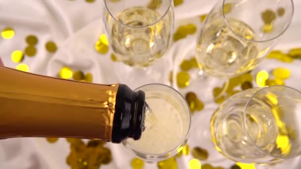 Pouring Bottle Sparkling Wine Glasses Background Confetti Slow Motion — Stok video