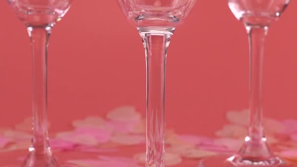 Sparkling Wine Poured Glasses Pink Background Heart Shaped Confetti — Stockvideo