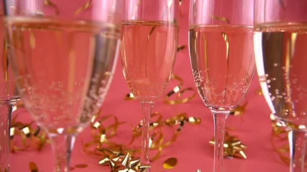 Falling Confetti Glasses Sparkling Wine Pink Background Serpentine Slow Motion — Vídeo de stock