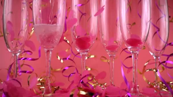 Sparkling Wine Poured Glasses Background Falling Confetti Form Hearts Pink — 图库视频影像