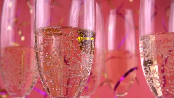 Falling Confetti Glasses Sparkling Wine Pink Background Slow Motion — Vídeo de stock