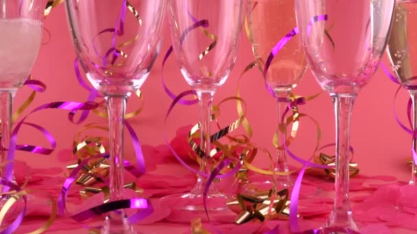 Pouring Sparkling Wine Glasses Pink Background Confetti Form Hearts Serpentine — Vídeo de stock