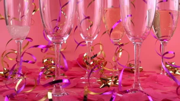 Pouring Sparkling Wine Glasses Pink Background Confetti Form Hearts Serpentine — Vídeo de stock