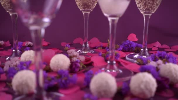 Sparkling Wine Poured Glass Purple Background Confetti Flowers Candy Coconut — Vídeo de stock