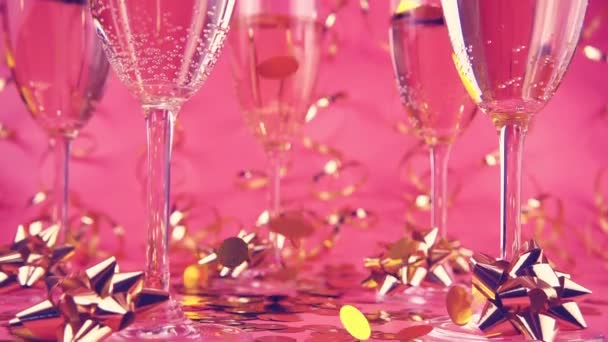 Falling Confetti Glasses Sparkling Wine Pink Background Serpentine Slow Motion — стоковое видео