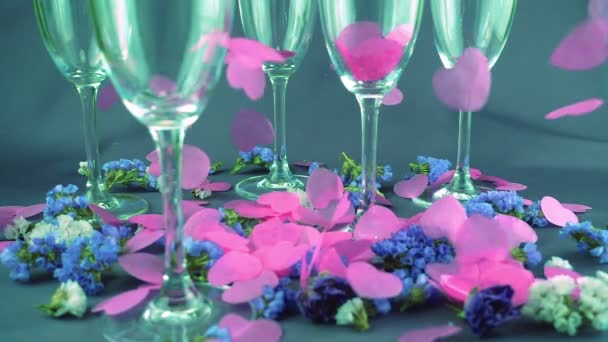 Falling Heart Shaped Confetti Glasses Wine Flowers Purple Background Slow — Stock Video