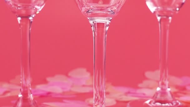 Sparkling Wine Poured Glasses Pink Background Heart Shaped Confetti — Vídeo de Stock