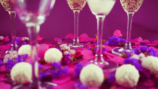Sparkling Wine Poured Glass Purple Background Confetti Flowers Candy Coconut — Video Stock