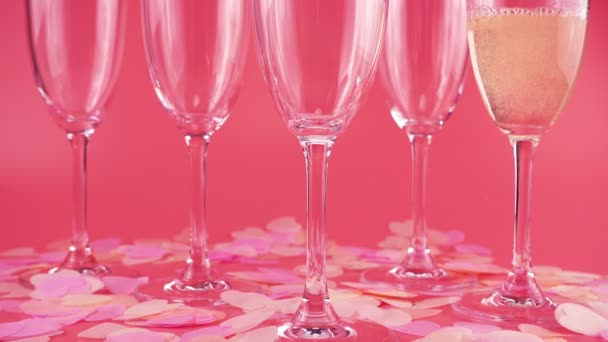Pouring Sparkling Wine Glasses Pink Background Heart Shaped Confetti — Stock video