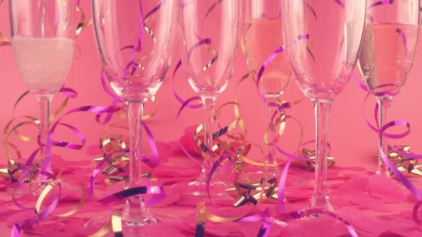 Pouring Sparkling Wine Glasses Pink Background Confetti Form Hearts Serpentine — 图库视频影像
