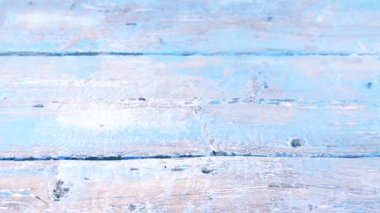 Colorful summer garden flowers: a bouquet of lilac sweet peas falls on a vintage wooden blue surface. Slow motion.
