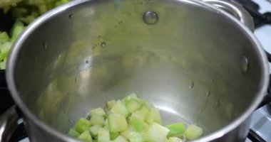 Braised zucchini slices in a saucepan.