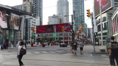 Pedestrian crossing on the YongeDundas Square (Dundas Square). It's public square at the southeast corner of the intersection of Yonge Street and Dundas Street East in Downtown Toronto, Ontario, Canada.