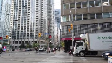 Skyscrapers, streets and pedestrian crossing in downtown Toronto, Ontario, Canada.