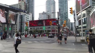 Pedestrian crossing on the Yonge-Dundas Square (Dundas Square). It's public square at the southeast corner of the intersection of Yonge Street and Dundas Street East in Downtown Toronto, Ontario, Canada.