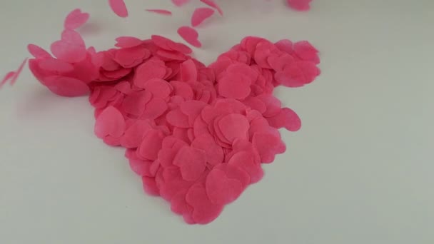 Heart Shaped Confetti Flies Wind Slow Motion Shooting White Background — Stock video