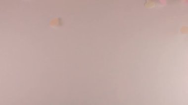 Confetti fly and make a heart shape. Slow motion.