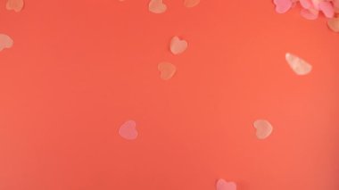 Confetti fly and make a heart shape. Slow motion.