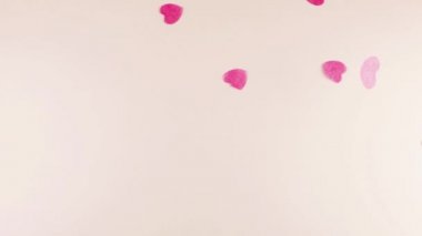 Confetti fly and make a heart shape. Slow motion.