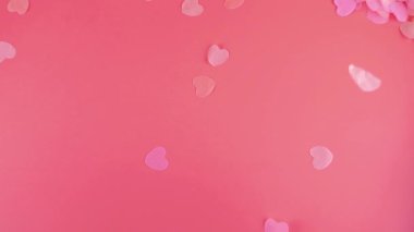 Confetti fly and make a heart shape. Slow motion.