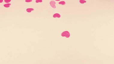 Confetti fly and make a heart shape. Slow motion.