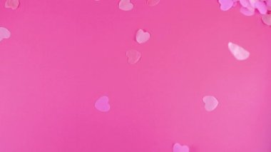 Confetti fly and make a heart shape. Slow motion.