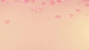 Confetti fly and make a heart shape. Slow motion.