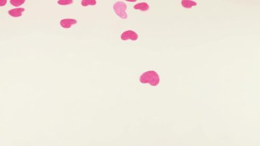 Confetti fly and make a heart shape. Slow motion.